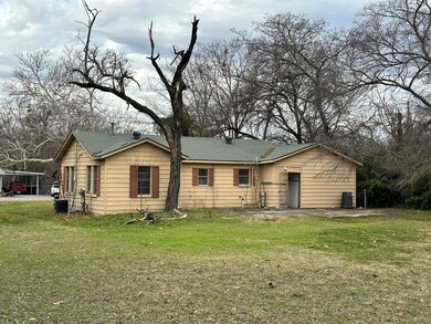 Back of property with central AC and a yard