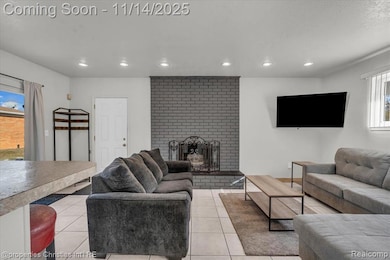 Living room featuring light tile patterned floors, a brick fireplace, and recessed lighting