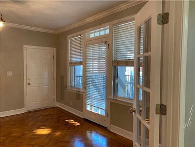Doorway with baseboards and ornamental molding