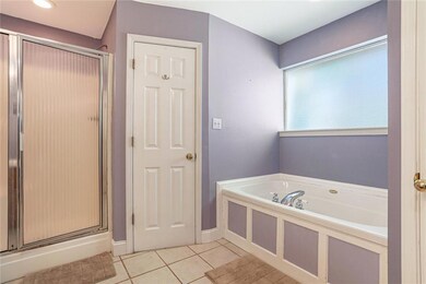 Primary bath features jetted tub, separate shower