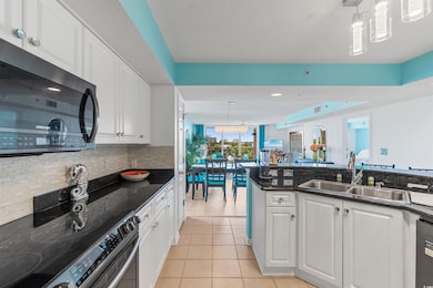 Kitchen with white cabinets, light hardwood / wood