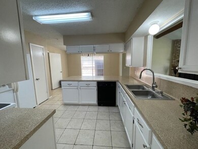 Kitchen featuring white cabinetry, modern applianc