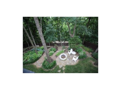 View from the deck of firepit and planting beds wi