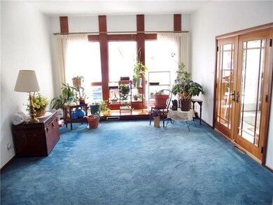 The family room is attached to the enclosed glass 