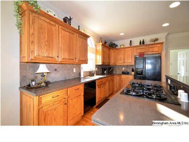 Kitchen features Corian countertops, black applian