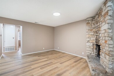 Unfurnished living room with visible vents, baseb