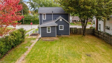 Rear view of house with a lawn