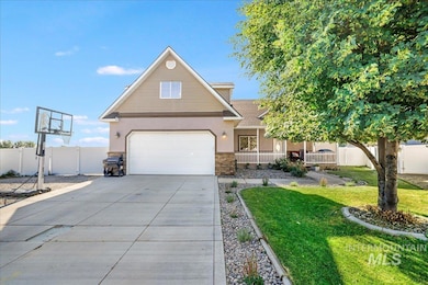 Traditional-style house with covered porch, concrete driveway, stone siding, stucco siding, and a shingled roof