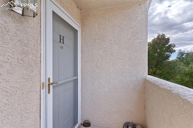 View of exterior entry featuring a balcony