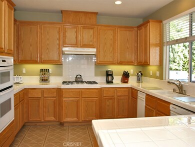 Large kitchen with walk in pantry, double oven, and window over sink that looks out to backyard.