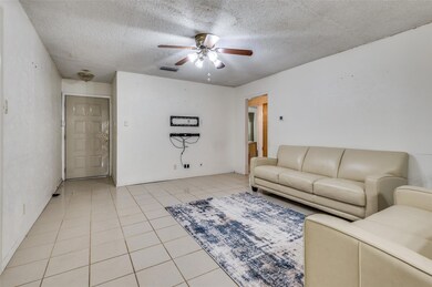 Living room featuring a textured ceiling, ceiling 