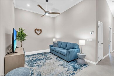 Living room featuring ceiling fan and ornamental m