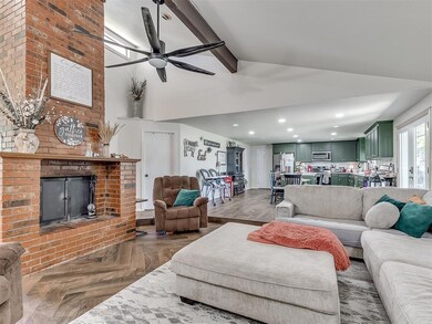 Living room with a brick fireplace, ceiling fan, p
