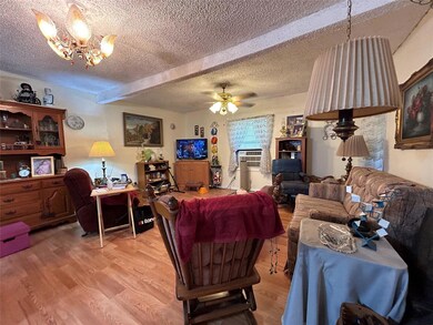 Living room featuring ceiling fan with notable cha