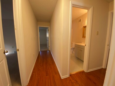 Corridor with dark wood finished floors and baseboards