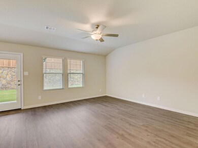 Unfurnished room with ceiling fan, wood-type flooring, and lofted ceiling