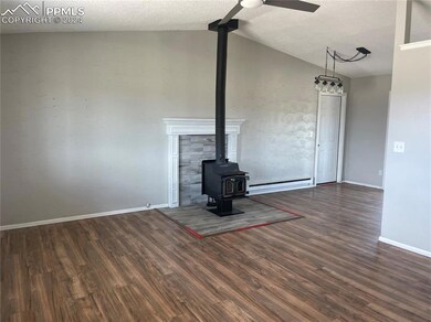 Great Room with hardwood floors and a woodburning 