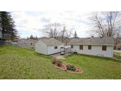 Back view.   Gently sloping backyard.