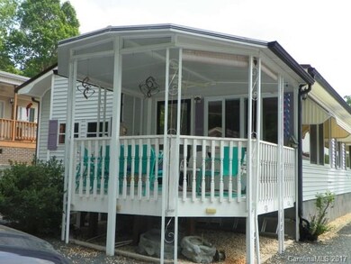 Covered back porch with ceiling fan and shades
