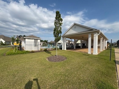 View of yard featuring a ceiling fan, a patio area, and a residential view