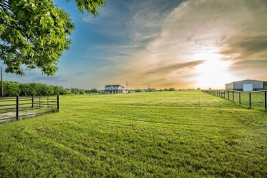 View of yard with a rural view and an outdoor structure