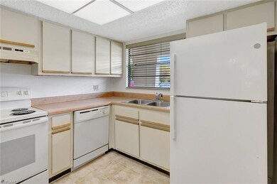 Kitchen featuring light tile patterned flooring, c