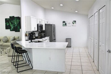 Kitchen featuring light tile patterned floors, vau