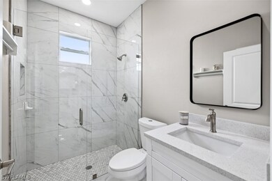 Bathroom with vanity, toilet, and walk in shower