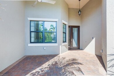 Property entrance with a ceiling fan, a patio area