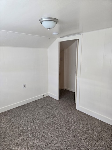 Spare room with dark carpet, baseboards, a smoke d