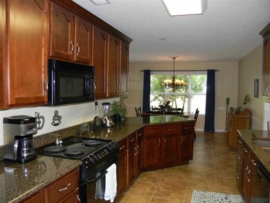 Kitchen features granite counter tops, under mount