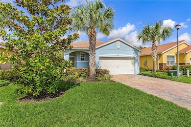 Mediterranean / spanish-style home featuring decorative driveway, stucco siding, a garage, a front lawn, and a tile roof
