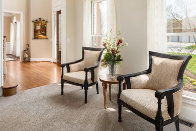 The formal living room/sitting room has lots of space and large windows to allow for natural light. This is a perfect spot to enjoy that morning cup of coffee.
