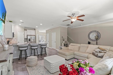 Living area featuring ornamental molding, a ceilin