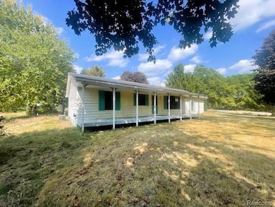 View of front facade featuring a front yard and a chimney