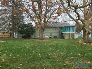 Stairs from sunroom to patio. Large yard.