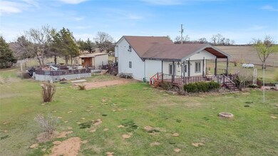 Rear view of property with a deck and a yard