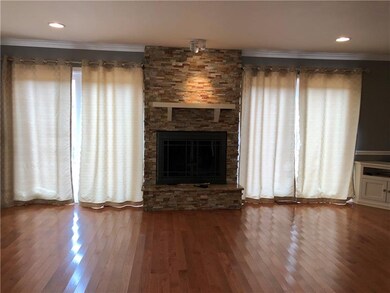 Living room with wood burning fireplace and deck a