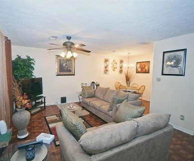 Living area featuring a textured ceiling, visible 