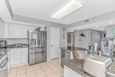 Kitchen with light tile patterned floors, visible 