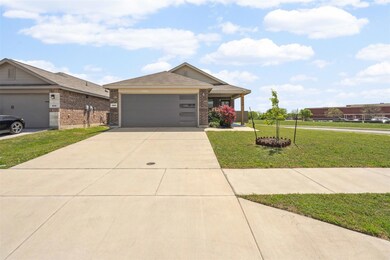 Ranch-style home with an attached garage, driveway