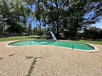 View of pool featuring a water slide and a patio