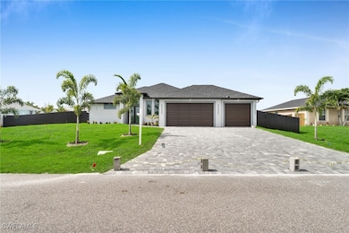 View of front of house with a garage and decorativ