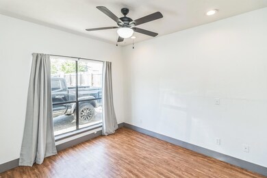 Spare room featuring wood finished floors, basebo