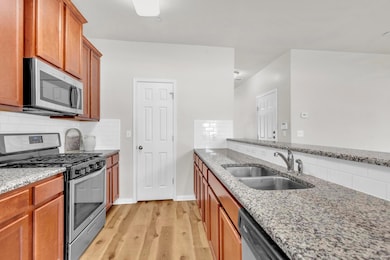 Kitchen with stainless steel appliances, a sink, 