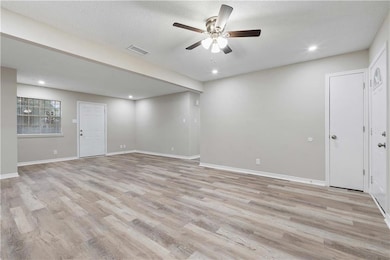 Unfurnished room with ceiling fan, a textured ceiling, and light hardwood / wood-style floors
