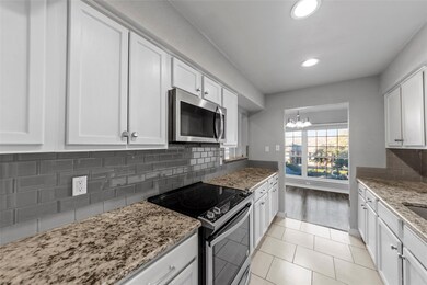 Kitchen featuring light stone counters, a notable 