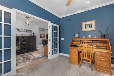 Office area featuring ornamental molding, light carpet, french doors, light tile patterned flooring, and ceiling fan