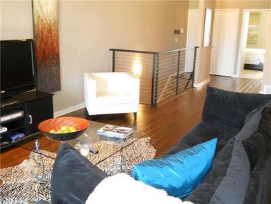Wide open living area with doors to balcony overlo