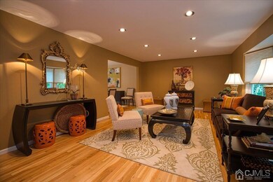 Formal living room, gleaming hardwood floors, rece